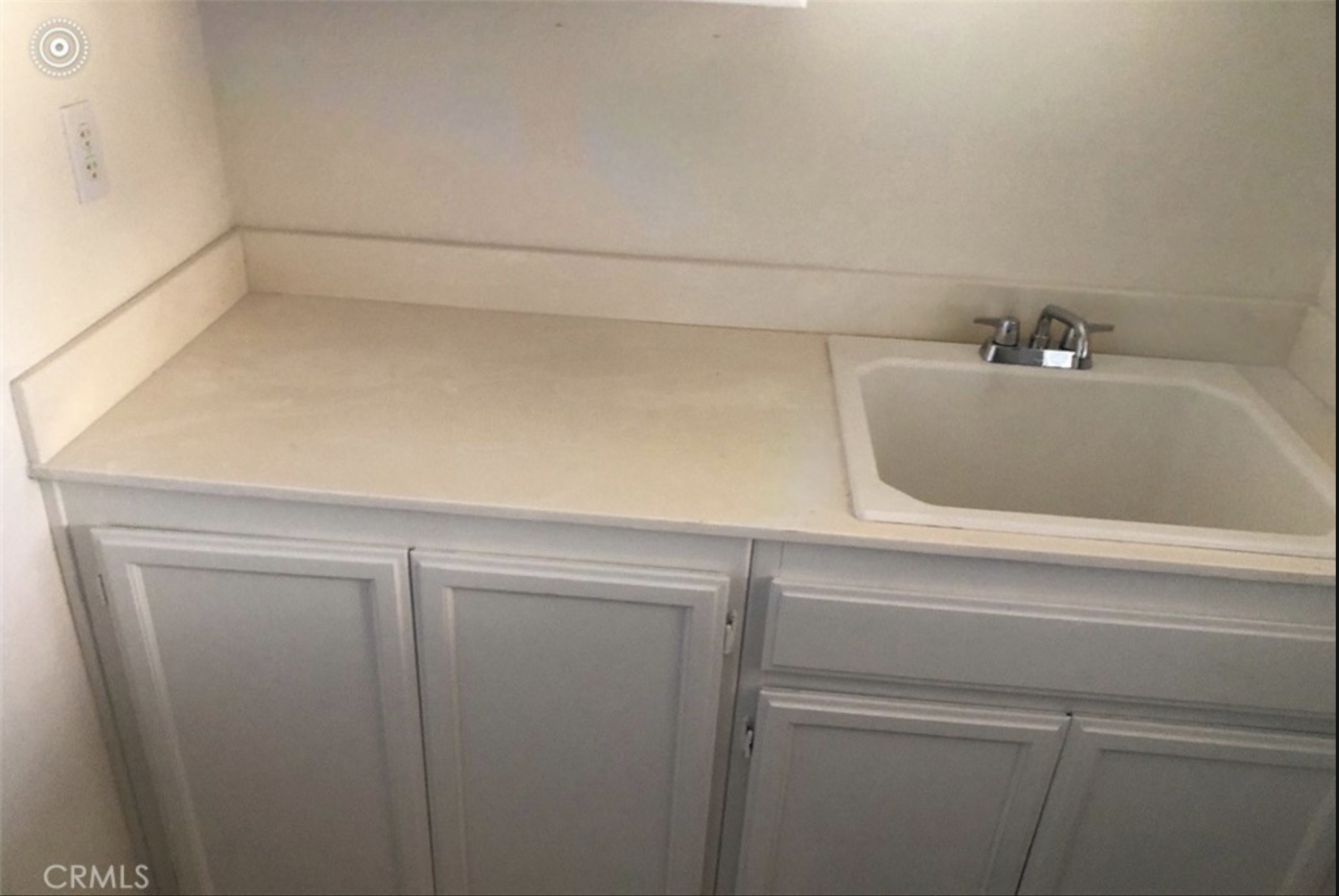 Laundry room counter and sink, seller's original listing photo, CRMLS watermark visible